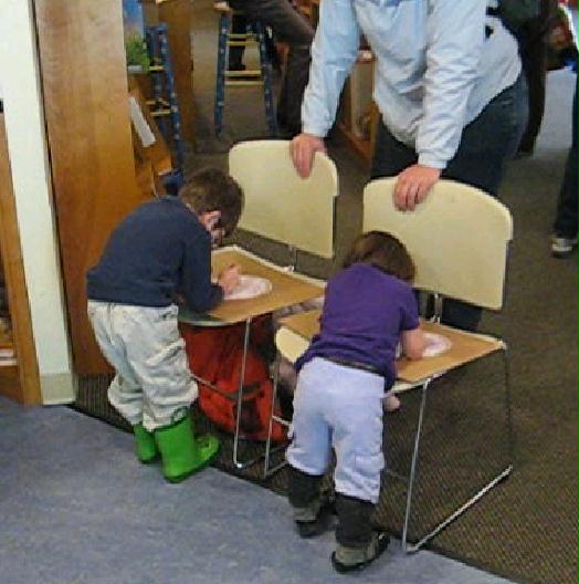 Kids Coloring on Chairs at a Craft Event Presented by David Udovic